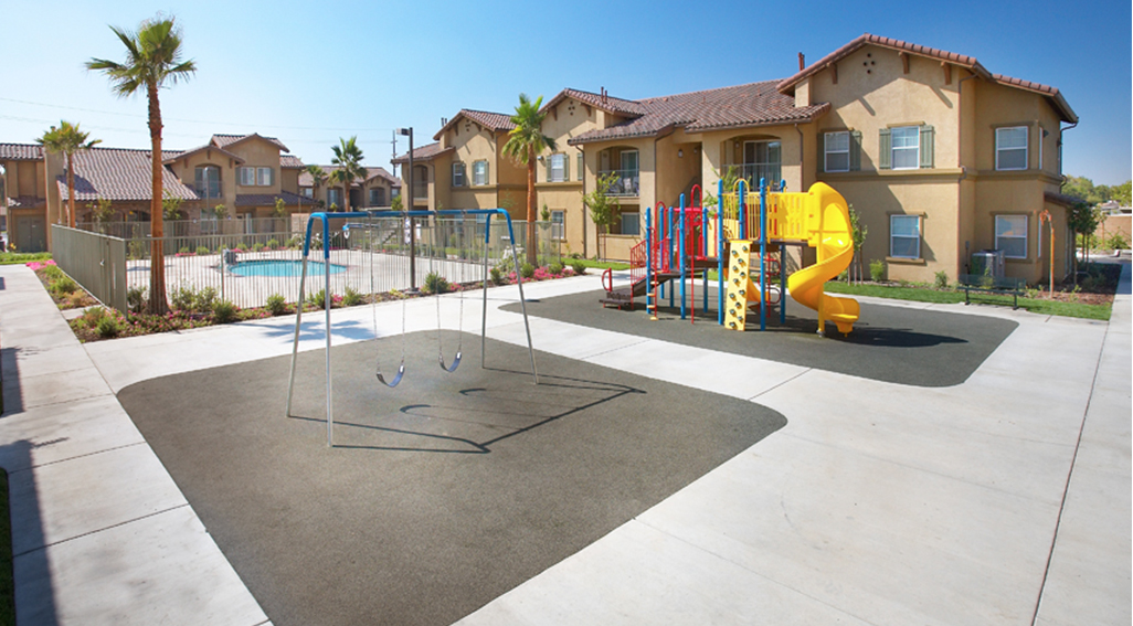 Sandstone apartment buildings and playground area