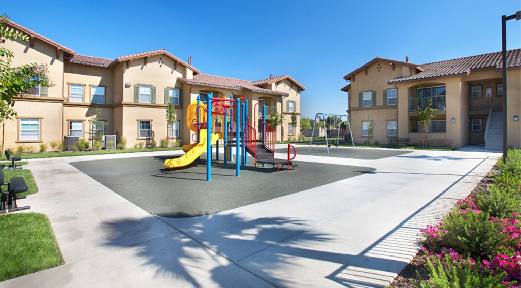 Sandstone apartment buildings and playground area