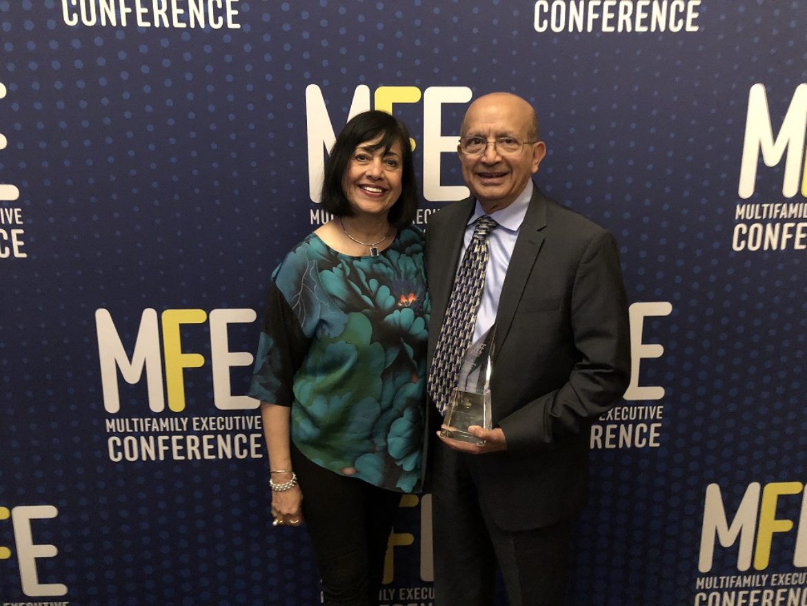Lux and Percy Vaz at Multifamily Executive Magazine conference holding award