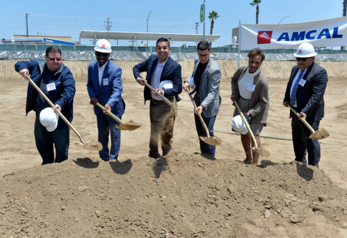 Photo of group of people with shovels of dirt at Las Ventanas apartments ground breaking ceremony