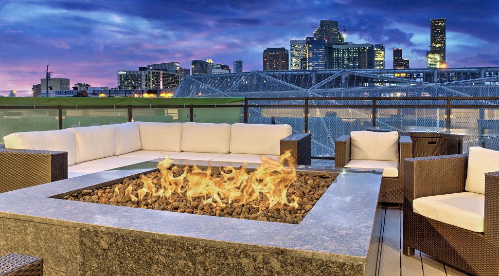 Circuit apartments fire pit area with view of city skyline