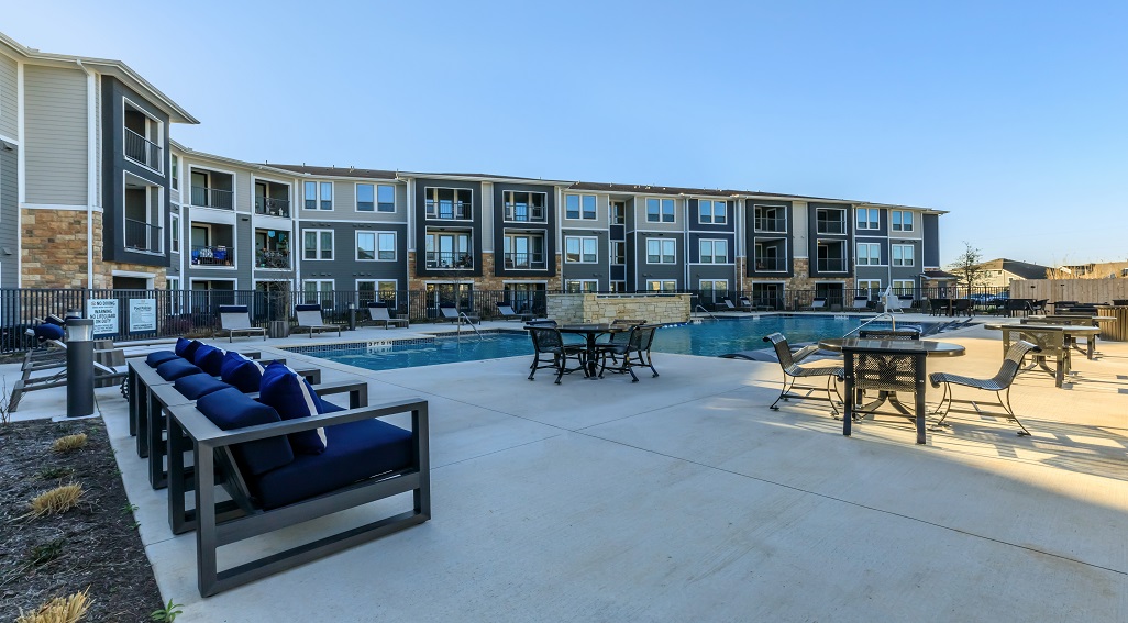 Limestone apartments overview with pool in foreground